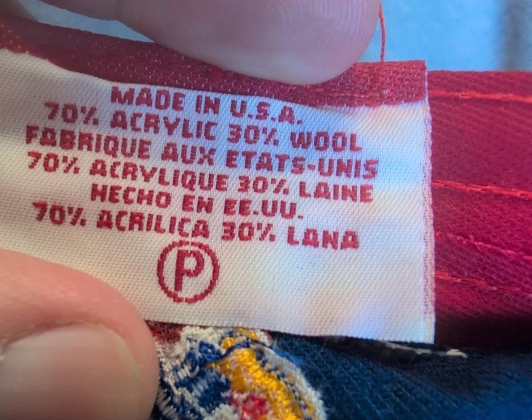 The content and origin tag inside a New Era Tyro.001 cap, reading Made in U.S.A., 70% acrylic 30% wool, printed in English, French, and Spanish